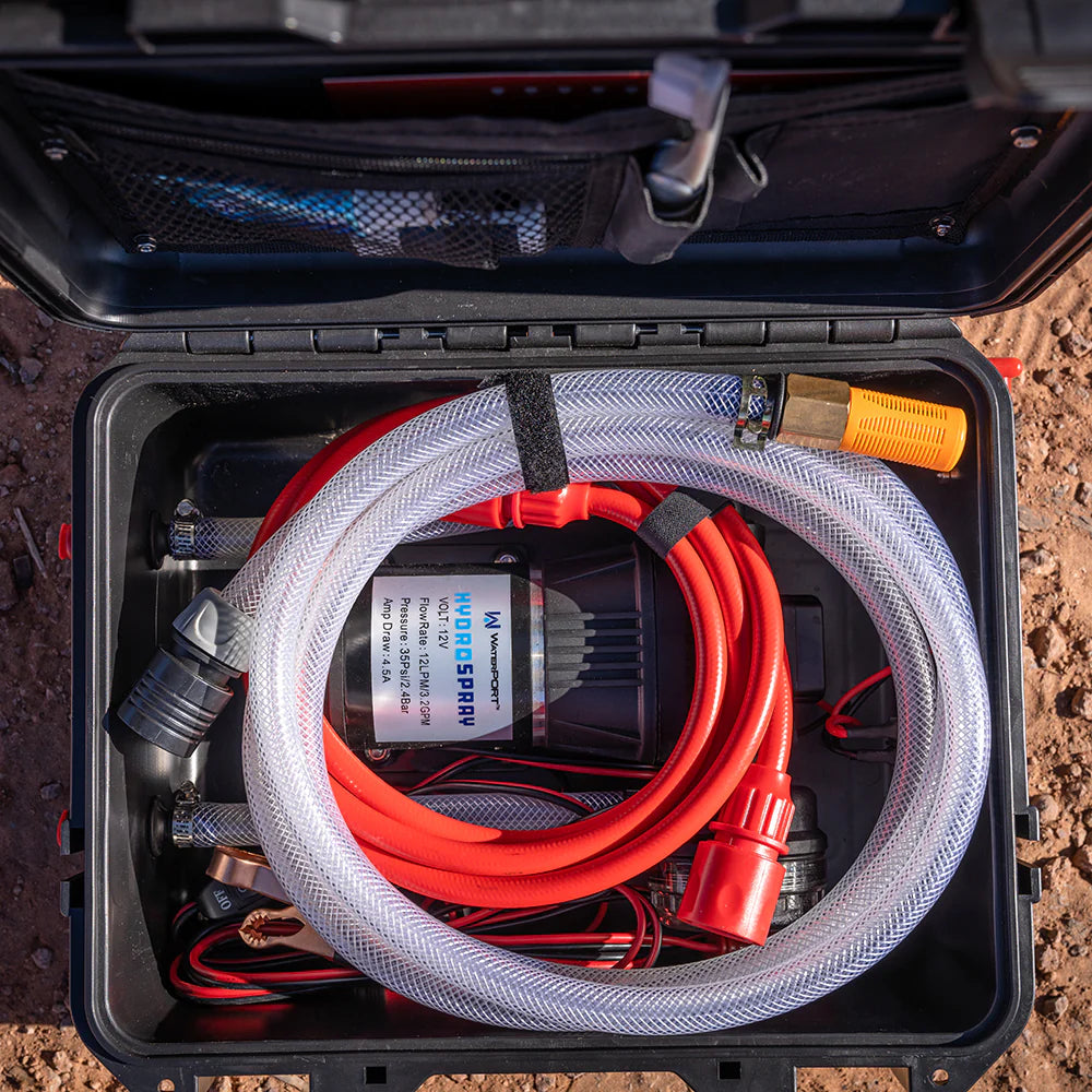 Top view of an open HydroSpray case to see components inside on a natural earth background